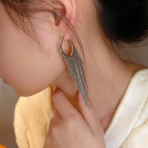 Elegant silver tassel drop earrings featuring long metal chain fringe on sleek C-shape hoops