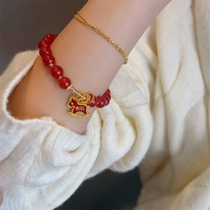 Red agate bead bracelet with golden rocking horse charm and lucky Chinese characters