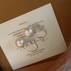 Detail of luxury snowflake pearl drop earrings with zircon tassel on vintage card