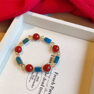 Vintage beaded bracelet with red agate, blue cylinder beads, and clear crystals for women