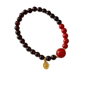 Vintage garnet bead bracelet with red enamel accents and gold relief oval pendant charms