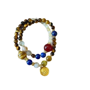 Double-layer tiger eye and blue gemstone beaded bracelet with a gold relief pendant