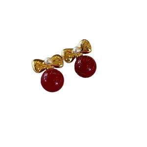 Festive red pearl bow earrings in gold finish with vintage red drop charms for women