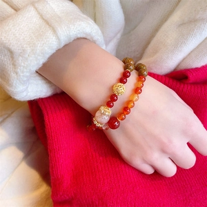 Ethnic double-layer bracelet featuring red agate beads and golden filigree accents
