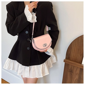 Detail of pink half-moon crossbody bag with silver chunky chain and metal twist lock
