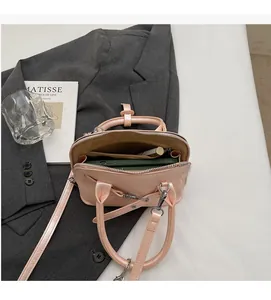Detailed interior view of a light pink shell bag showing spacious storage capacity