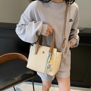 Women's large woven tote bag with brown leather trim and cute bear charm pendant