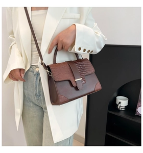 Brown faux leather crossbody bag with crocodile pattern and adjustable shoulder strap
