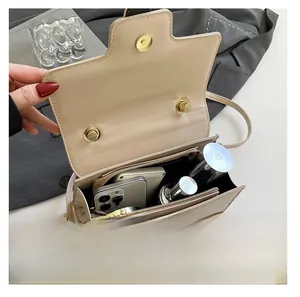 Detailed interior view of the beige faux leather bag showing its spacious compartments
