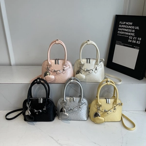 Chic shell-shaped handbag in five colors on marble steps for a modern fashion look