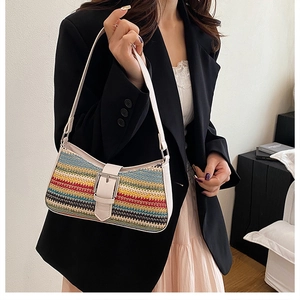 Detail of colorful woven shoulder bag with wavy texture and white leather strap