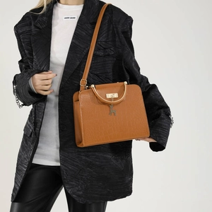 Brown crocodile pattern handbag with metal deer pendant and circular handle for daily use
