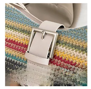 Detail of colorful woven straw pattern with leather strap and silver buckle