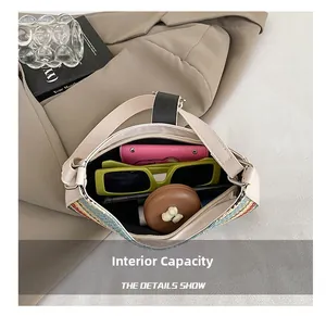 Internal capacity of rainbow straw bag showing wallet, phone, and sunglasses