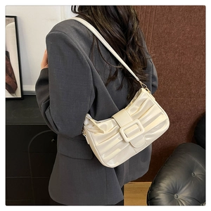 Vue détaillée du sac sous le bras plissé blanc crème avec une grande boucle carrée élégante