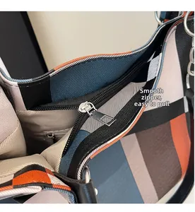 Detailed close-up of smooth silver zipper and colorful geometric fabric on tote bag