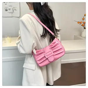Détail du sac bandoulière plissé rose avec une boucle rectangulaire et un design en nœud