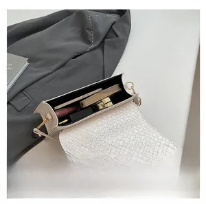 Macro view of white crocodile pattern bag showing spacious interior for essentials
