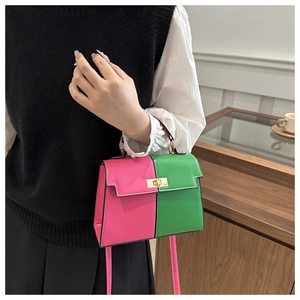 Detail of color-block Kelly bag in pink and green with gold twist lock and top handle