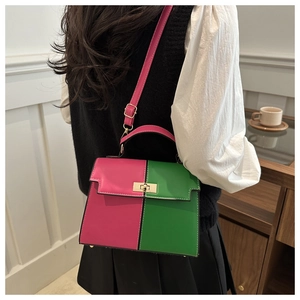 Contrast Kelly bag in magenta and green with gold buckle worn on the shoulder by a model