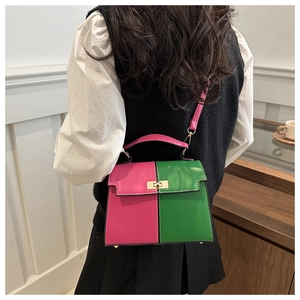 Detail of color-block Kelly bag with pink and green leather and golden metal clasp