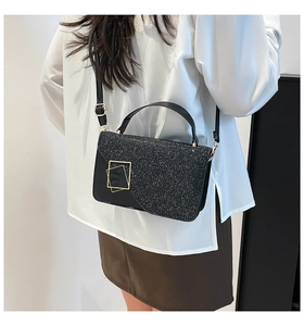 Fashionable black crossbody bag with silver glitter flap and gold metal buckle detail