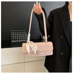 Pink shoulder bag detail with silk scarf strap and silver rhinestone buckle decor