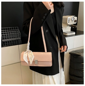 Detail of pink shoulder bag with sparkling rhinestone buckle and stylish silk scarf wrap
