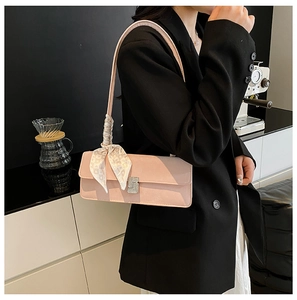 Pink faux leather baguette bag with a crystal buckle and printed silk scarf detail