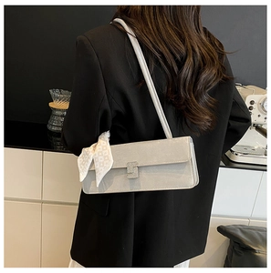 Chic grey shoulder bag with diamond S-buckle and silk scarf detail on model