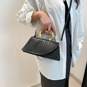 Black woven texture trapezoid handbag with unique gold wavy metal handle for women