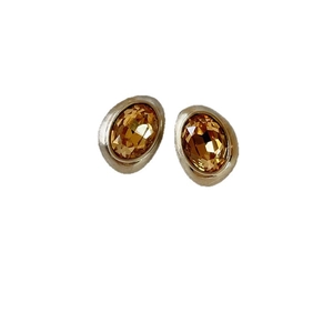 Irregular brushed oval stud earrings with faceted amber glass stones and metallic base