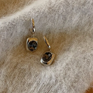 Detailed view of vintage silver drop earrings with faceted grey rectangular crystal