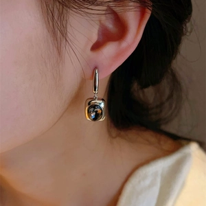 Close-up of vintage geometric square earrings with sparkling smoky grey cut stones