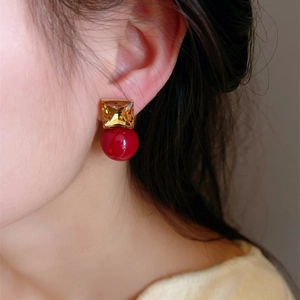 Elegant amber square crystal and red round pearl stud earrings for women shown on model