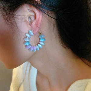 Sweet macaron beaded hoop earring with blue-purple gradient pearls on a female model