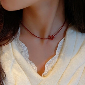 Handmade Czech bead necklace with red seeds and retro flower pendant worn by model