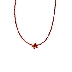 Retro red beaded necklace featuring a delicate handmade flower pendant on white background