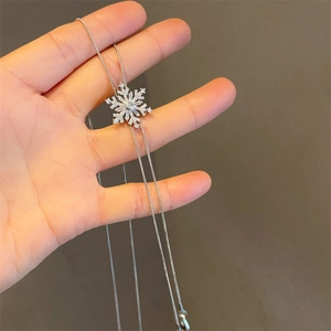 Elegant silver snowflake pendant necklace with white zircons on a snake chain
