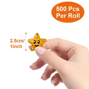 Roll of 500 gold glitter star stickers with smile emoji faces, 1 inch diameter size