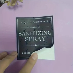 Macro detail of waterproof black square labels for sanitizing spray bottles with water droplets