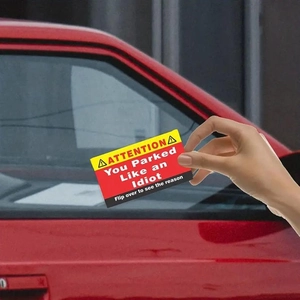 Close-up of You Parked Like an Idiot prank cards with bold warning and yellow design