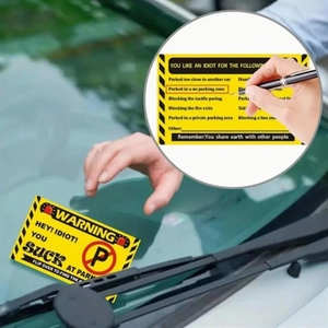 Macro detail of yellow no parking warning card showing checkboxes for illegal parking reasons