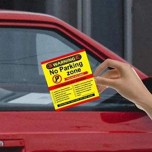 Warning card being placed on a car window to report illegal parking violations