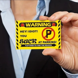 Bright yellow illegal parking warning cards with red text held in hand for visibility