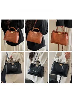 Detail shots of crocodile embossed handbags in brown and black with gold twist locks