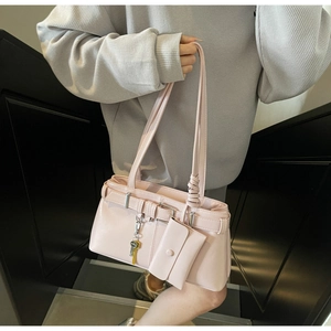 Pink glossy underarm bag with belt buckle detail and matching mini coin purse accessory