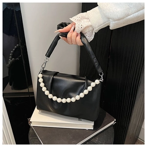 Détail du sac nuage plissé noir avec chaîne en perles blanches et poignée souple