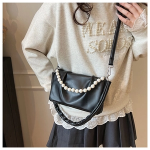 Détail du sac nuage noir plissé avec chaîne en perles et texture PU souple