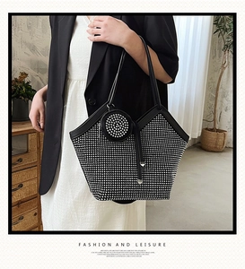 Detail of black rhinestone tote bag with matching round coin purse on a lifestyle setting